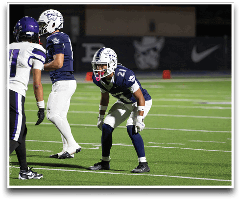 Three football players are standing on the field, one of them is smiling and wearing a black jersey with the number 55. AI generated content