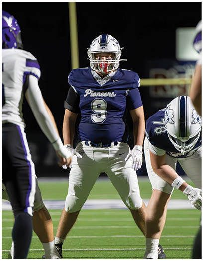 A football player wearing a blue and white uniform. Description generated by AI