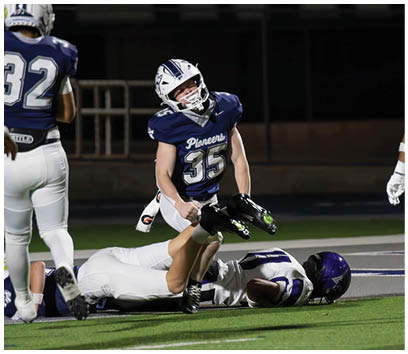 A football player wearing a blue and white uniform. Description generated by AI