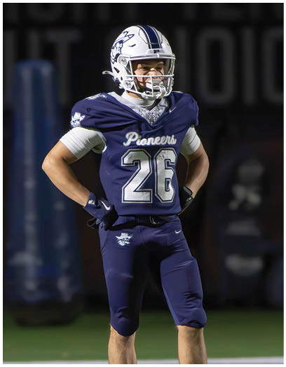 A football player wearing a blue and white uniform. Description generated by AI