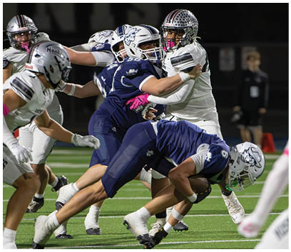A football player wearing a blue and white uniform. Description generated by AI