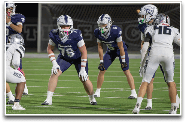 Three football players are standing on the field, one of them is smiling and wearing a black jersey with the number 55. AI generated content
