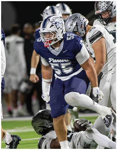 A football player wearing a blue and white uniform. Description generated by AI