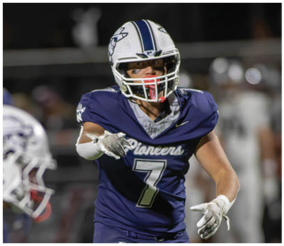 A football player wearing a blue and white uniform. Description generated by AI