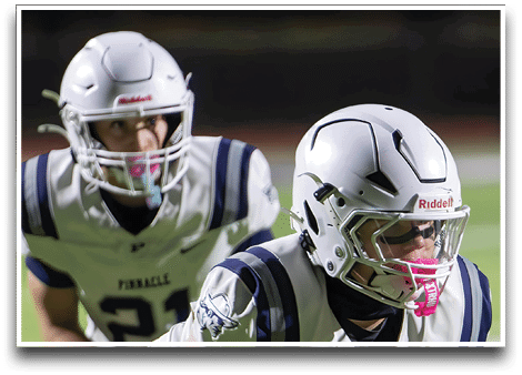 Three football players are standing on the field, one of them is smiling and wearing a black jersey with the number 55. AI generated content