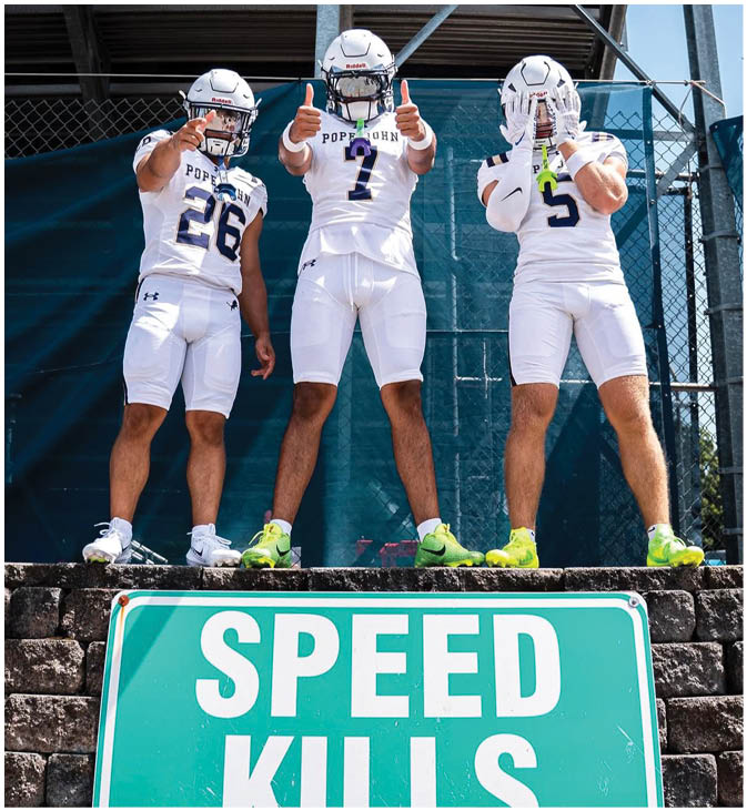 A group of football players wearing black and white uniforms. Description generated by AI