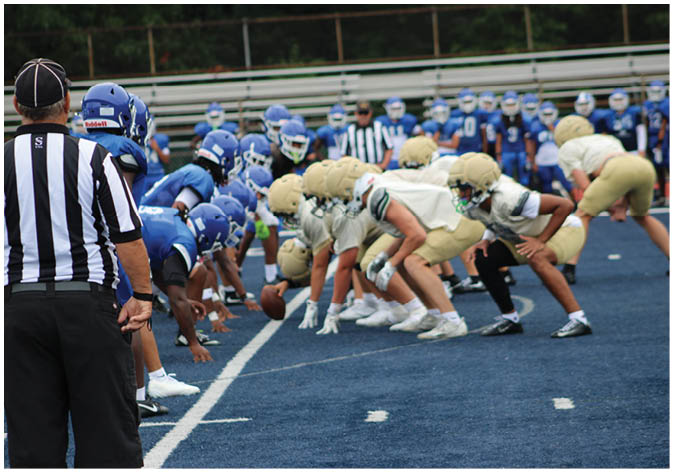 A group of football players wearing black and white uniforms. Description generated by AI