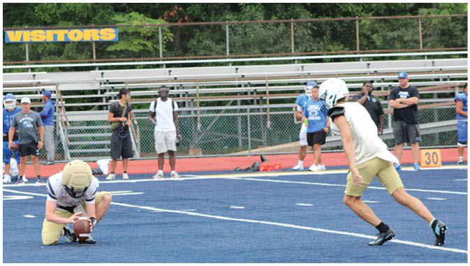 A group of football players on a field. Description generated by AI