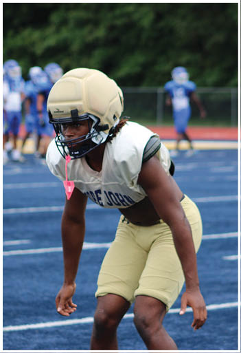 A football player running on the field. Description generated by AI