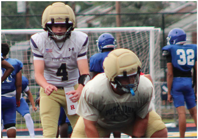 A group of football players wearing black and white uniforms. Description generated by AI