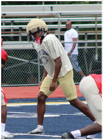 A football player wearing a blue jersey with the number 58 on it. Description generated by AI