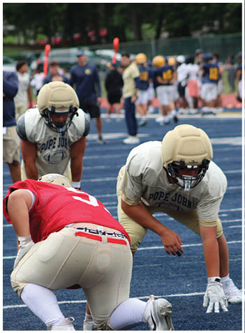 A football player wearing a blue jersey with the number 58 on it. Description generated by AI
