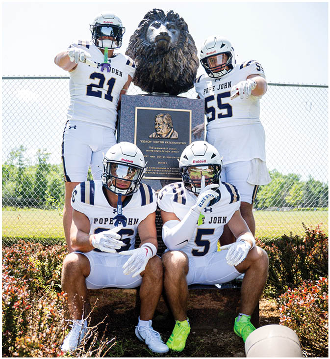 A group of football players wearing black and white uniforms. Description generated by AI