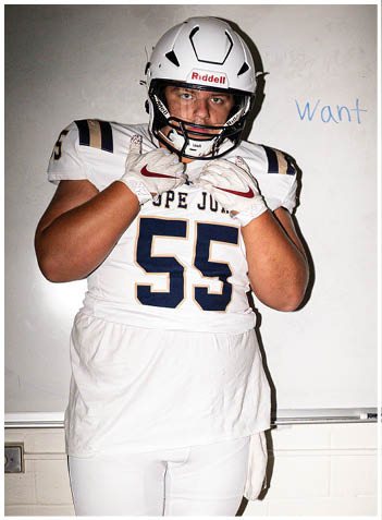 A football player wearing a blue jersey with the number 58 on it. Description generated by AI
