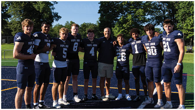 A group of football players on a field. Description generated by AI
