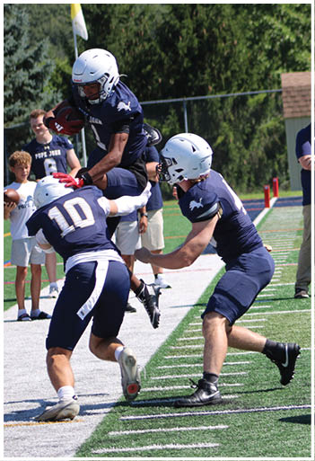 A football player running on the field. Description generated by AI