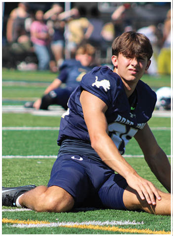 A football player wearing a blue jersey with the number 58 on it. Description generated by AI