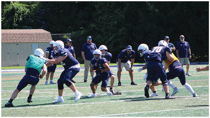 A group of football players on a field. Description generated by AI