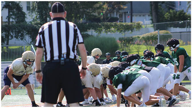 A group of football players on a field. Description generated by AI