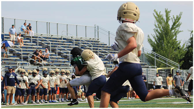 A group of football players on a field. Description generated by AI