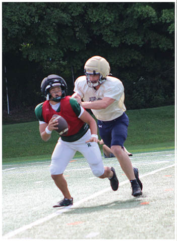 A football player wearing a blue jersey with the number 58 on it. Description generated by AI