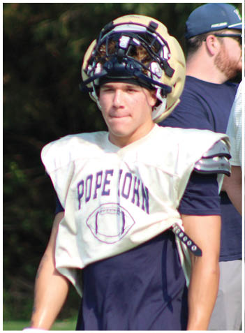 A football player wearing a blue jersey with the number 58 on it. Description generated by AI