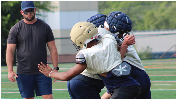 A group of football players on a field. Description generated by AI