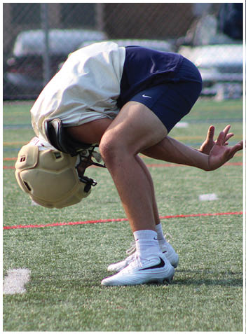 A football player wearing a blue jersey with the number 58 on it. Description generated by AI