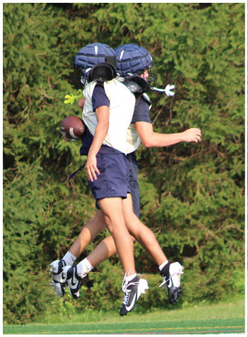 A football player wearing a blue jersey with the number 58 on it. Description generated by AI