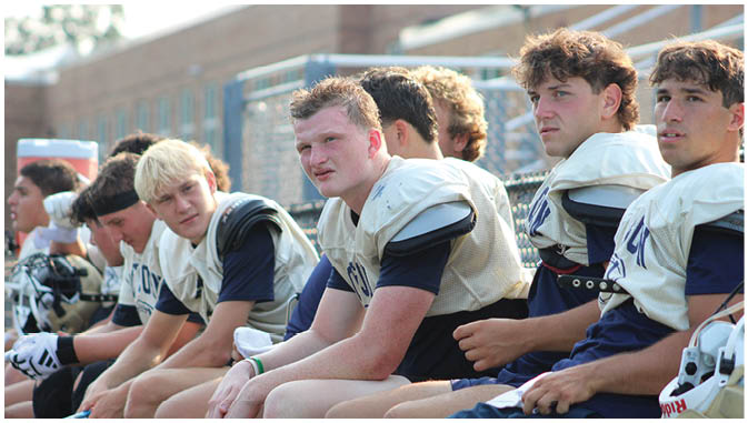 A group of football players on a field. Description generated by AI