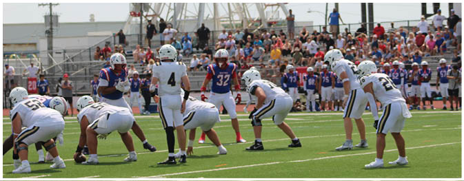 A group of football players on a field. Description generated by AI