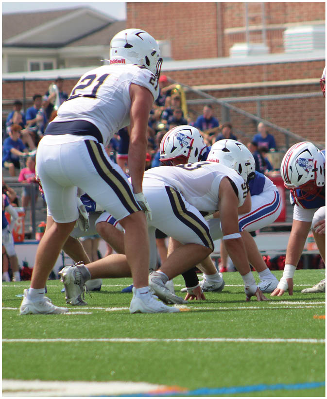 A group of football players on a field. Description generated by AI