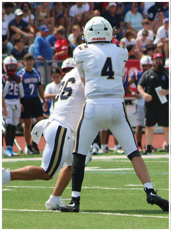 A group of football players celebrating a touchdown. Description generated by AI