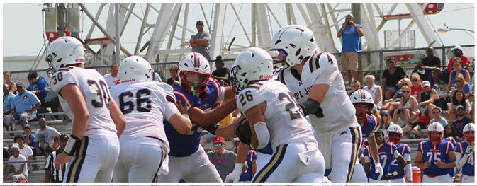 A group of football players on a field. Description generated by AI
