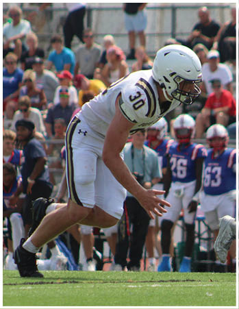A group of football players celebrating a touchdown. Description generated by AI