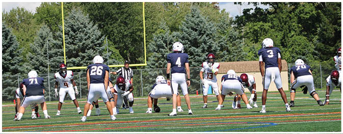 A group of football players on a field. Description generated by AI