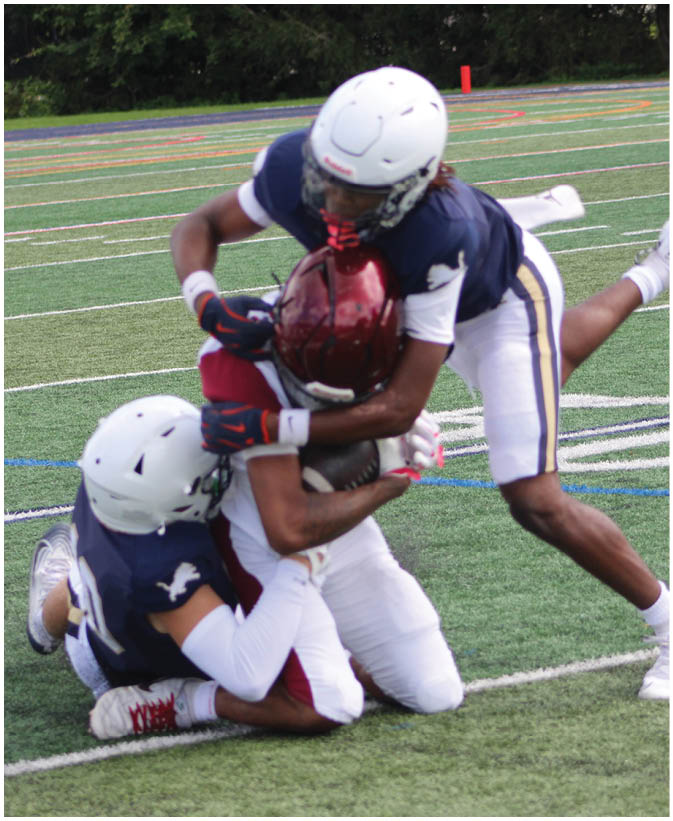 A group of football players on a field. Description generated by AI