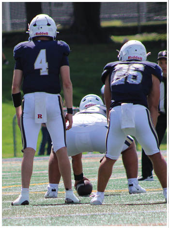 A group of football players celebrating a touchdown. Description generated by AI