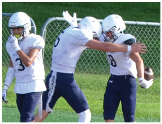 A group of football players on a field. Description generated by AI