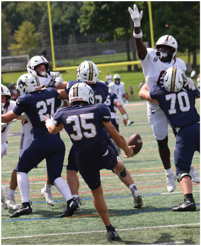 A group of football players on a field. Description generated by AI