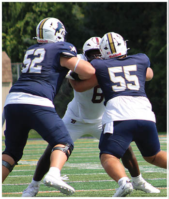 A group of football players celebrating a touchdown. Description generated by AI