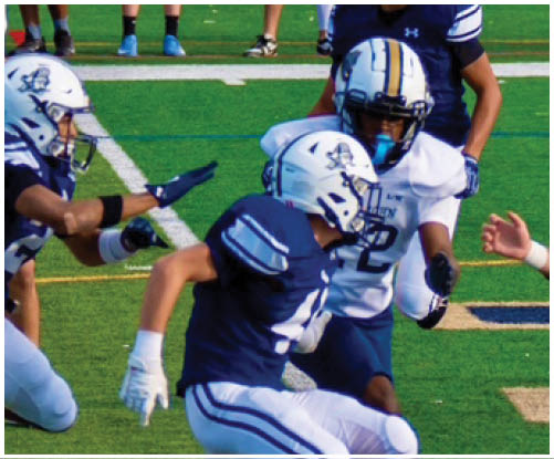 A football player wearing a blue and white uniform. Description generated by AI