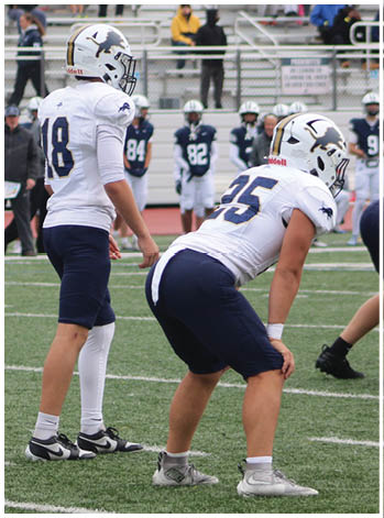 A group of football players celebrating a touchdown. Description generated by AI