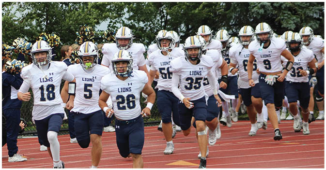 A group of football players on a field. Description generated by AI