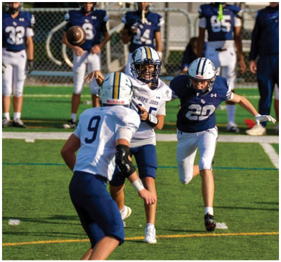 A football player wearing a blue and white uniform. Description generated by AI