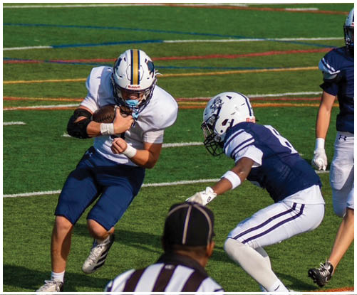 A football player wearing a blue and white uniform. Description generated by AI