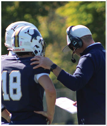 A group of football players celebrating a touchdown. Description generated by AI