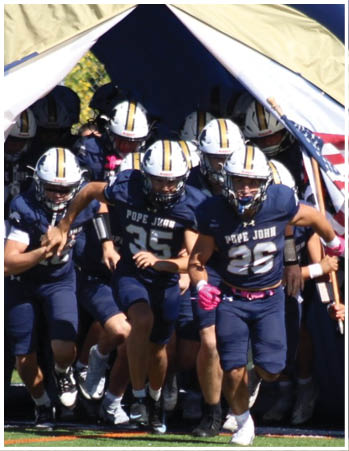 A group of football players celebrating a touchdown. Description generated by AI