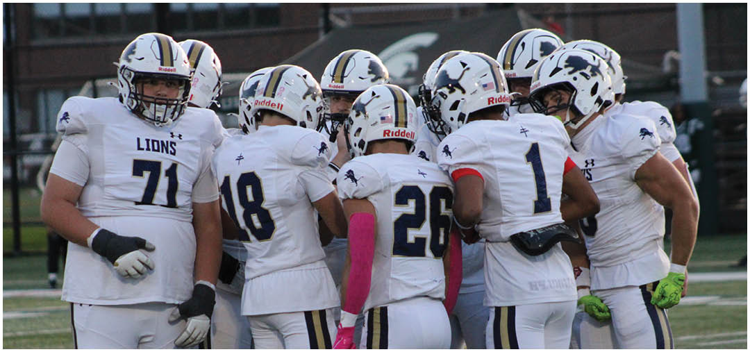 A group of football players on a field. Description generated by AI