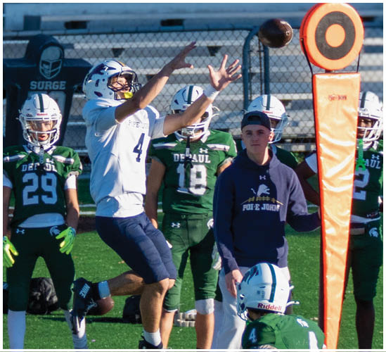 A football player wearing a blue and white uniform. Description generated by AI